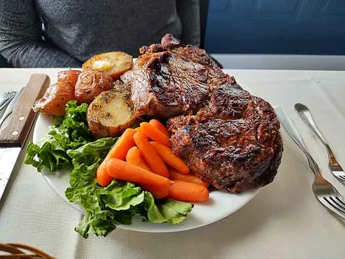 Medium-rare ribeye with golden potatoes and carrots